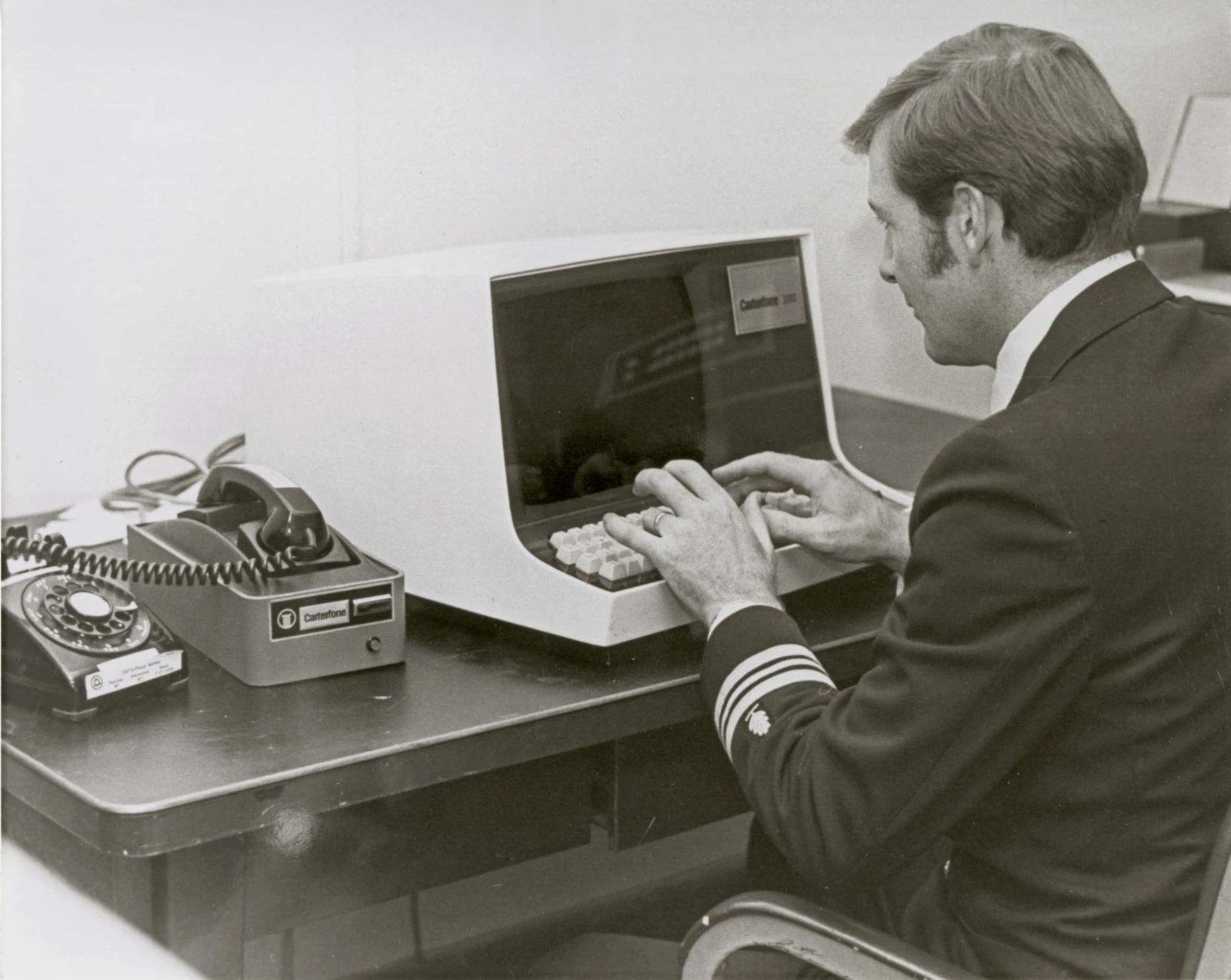A gentleman typing in an old computer